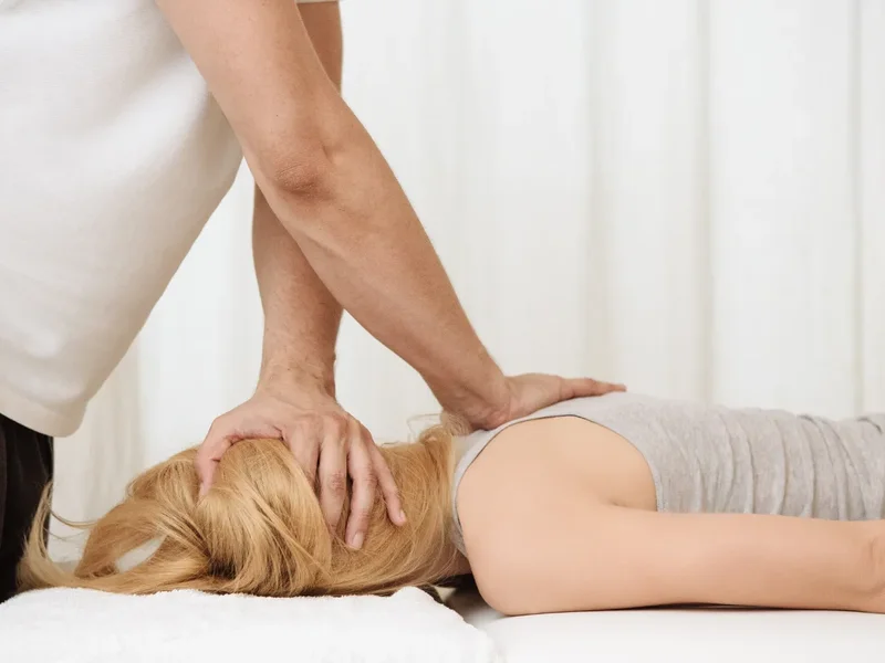 Physical therapist assessing a patient's movement related to chronic pain