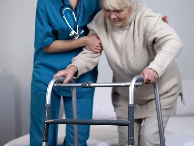 Physical therapist assessing a patient's movement related to hip replacement surgery