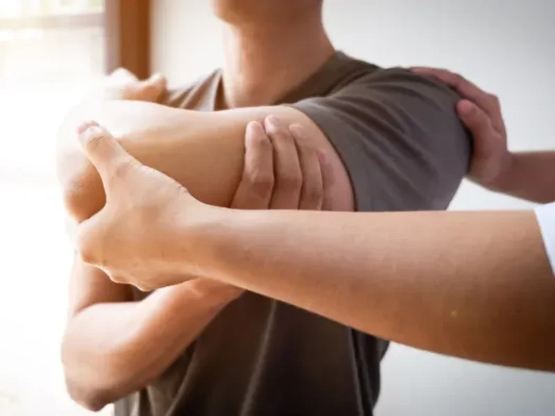 Physical therapist assessing a patient's movement related to rotator cuff tears