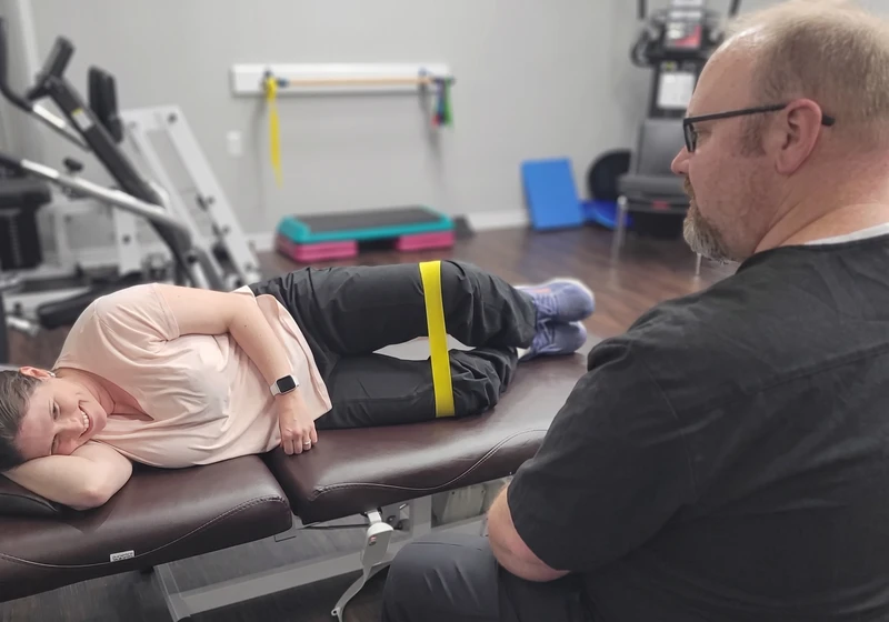 Physical therapist guiding a patient through a hands-on treatment session